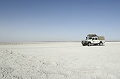 Safari vehicle on a dry salted lake Botswana