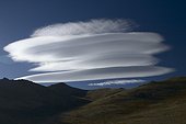 Lenticular cloud with the top of the solid mass of Tien Shan  