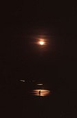 Man in a reflection of Moon eclipse on Loire river France