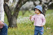 20 month old girl blowing on a seed dandelion France