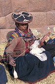 Woman in traditional clothe spinning wool Peru