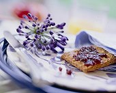 Blue flower and biscuit on plate