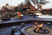 Terrace and fire near a watering place in a luxury lodge