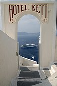 Entering a hotel overlooking a ferry in the caldera