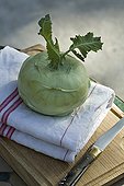 Kohlrabi and Laguiole knife on a wooden tray