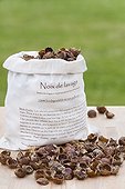 Dried soapnuts in canvas bag on wooden table France