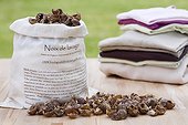 Dried soapnuts and pile of clean garments in France