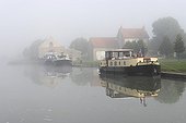 Barges in fog on the Canal de Bourgogne France 