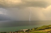 Double lightning in a curtain of rain over the Lake Geneva 
