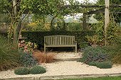 Pergola and bench The Garden of Marie-Ange Croisette ; Coneflower (yellow flower), Autumn Sedge, Everbrown sedge, Hydrangea, rose-tree and Dianthus