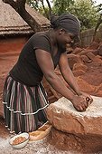 Shangaan woman grinding peanuts Southern Africa