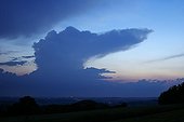 Isolated cumulonimbus clouds at dusk in the spring France ; At altitude, the wind southerly "décoiffe" the cloud top by creating a half-anvil (incus Cumulonimbus capillatus)