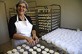 Cheesemaker handling of fresh goat cheeses France 