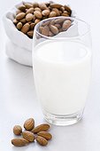 Glass of Almond Milk and Almond Kernels bag