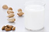 Glass of Almond Milk and Almonds peeled and whole 