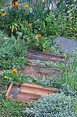 Old tiles made garden path in a garden