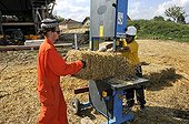Cutting hay bales for wood-frame house France ; Coated natural lowland bioclimatic energy HQE<br>Orchard House Landscape and Energy 
