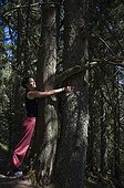 Woman hugging a tree Forest Soultzeren Vosges France