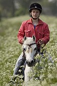 Pony Rider and Wild Chervil at spring in Netherlands