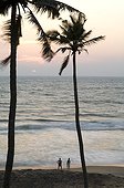 Tourists at the Golden Sunset Beach Kerala India 