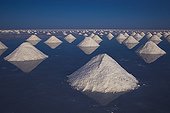 Artificial salt mounts in Salar de Uyuni Altiplano Bolivia ; The salt has been shoveled to mounts by salt workers for the salt to dry