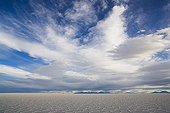 Interesting cloud formations above Salar de Uyuni Bolivia ; Hexagons evolve a few months after salt pan has dried up