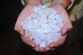 Close up of hand showing hail-stones after a hailstorm