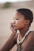 Young girl San wearing traditional skins Namibia ; In the private reserve named "N/a’an ku sê", welfare programs and health support converge to maintain populations of Bushmen in good health and to reintroduce the wild Cheetahs. This nomadic group of hunter-gatherers has a history dating back over 20,000 years. Their close relationship and perfect their knowledge of animals allowed to live and feed in the deserts of southern Africa.