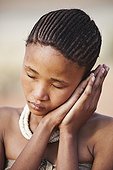 Portrait of young San girl in the Namib desert Namibia ; In the private reserve named "N/a’an ku sê", welfare programs and health support converge to maintain populations of Bushmen in good health and to reintroduce the wild Cheetahs. This nomadic group of hunter-gatherers has a history dating back over 20,000 years. Their close relationship and perfect their knowledge of animals allowed to live and feed in the deserts of southern Africa.