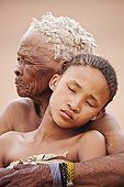 Young San girl with old woman embracing in Namibia ; In the private reserve named "N/a’an ku sê", welfare programs and health support converge to maintain populations of Bushmen in good health and to reintroduce the wild Cheetahs. This nomadic group of hunter-gatherers has a history dating back over 20,000 years. Their close relationship and perfect their knowledge of animals allowed to live and feed in the deserts of southern Africa.