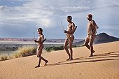 Male San hunters armed with traditional bow and arrow ; In the private reserve named "N/a’an ku sê", welfare programs and health support converge to maintain populations of Bushmen in good health and to reintroduce the wild Cheetahs. This nomadic group of hunter-gatherers has a history dating back over 20,000 years. Their close relationship and perfect their knowledge of animals allowed to live and feed in the deserts of southern Africa.