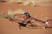 Male San hunter armed with traditional bow and arrow ; In the private reserve named "N/a’an ku sê", welfare programs and health support converge to maintain populations of Bushmen in good health and to reintroduce the wild Cheetahs. This nomadic group of hunter-gatherers has a history dating back over 20,000 years. Their close relationship and perfect their knowledge of animals allowed to live and feed in the deserts of southern Africa.