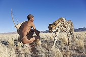 San hunter armed with traditional bow and arrow with cheetah ; In the private reserve named "N/a’an ku sê", welfare programs and health support converge to maintain populations of Bushmen in good health and to reintroduce the wild Cheetahs. This nomadic group of hunter-gatherers has a history dating back over 20,000 years. Their close relationship and perfect their knowledge of animals allowed to live and feed in the deserts of southern Africa.
