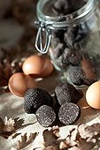 Harvest of black truffles in a jar and eggs
