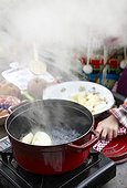 Children making apple sauce