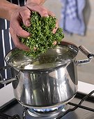 Adding curly kale to boiling water