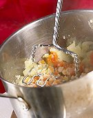 Mashing carrots and potatoes for hotchpotch