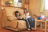 Jack Russell Terrier and children on a sofa on holidays