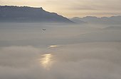 Morning fog on lake Bourget and airliner France ; The aircraft was approaching the airport of Chambery - Savoie. 