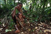 Pygmy Baaka child playing with a machete Cameroon ; All young children are already learning to use a machete, the basic tool of elementary 