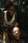 Pygmy women Baaka hats South-eastern Cameroon ; Women help each other maintain their hair