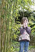 Girl playing a kazoo reed and paper ; Girl aged 5 years 