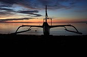 Trimaran silhouette at sunset Bali Lovina beach