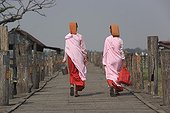 Nuns walking on the bridge of U Bein of Amarapura Myanmar