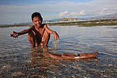 Boy playing with a boat Messah Pulau Flores Indonesia 