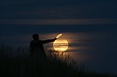 Partial Lunar Eclipse ; During the partial eclipse of the Moon on September 7, 2006, a young woman holding a piece of Moon in her hand as if she had raised the hood.
