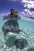 Tourists and Pink Whipray in Tahaa in French Polynesia
