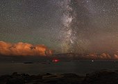 Shooting star in the Milky Way above the sea France ; The Milky Way stands vertically on the night of the Perseids, a meteor swarms of the most abundant of the year. One of them left a trace in the heart of the Milky Way. 