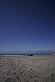 Low Perseids and summer triangle above a beach  ; Perseid low left Deneb at the top of the great Summer Triangle.