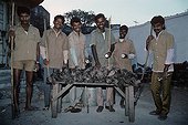 Night rat hunters with their trophies at night Bombay India 